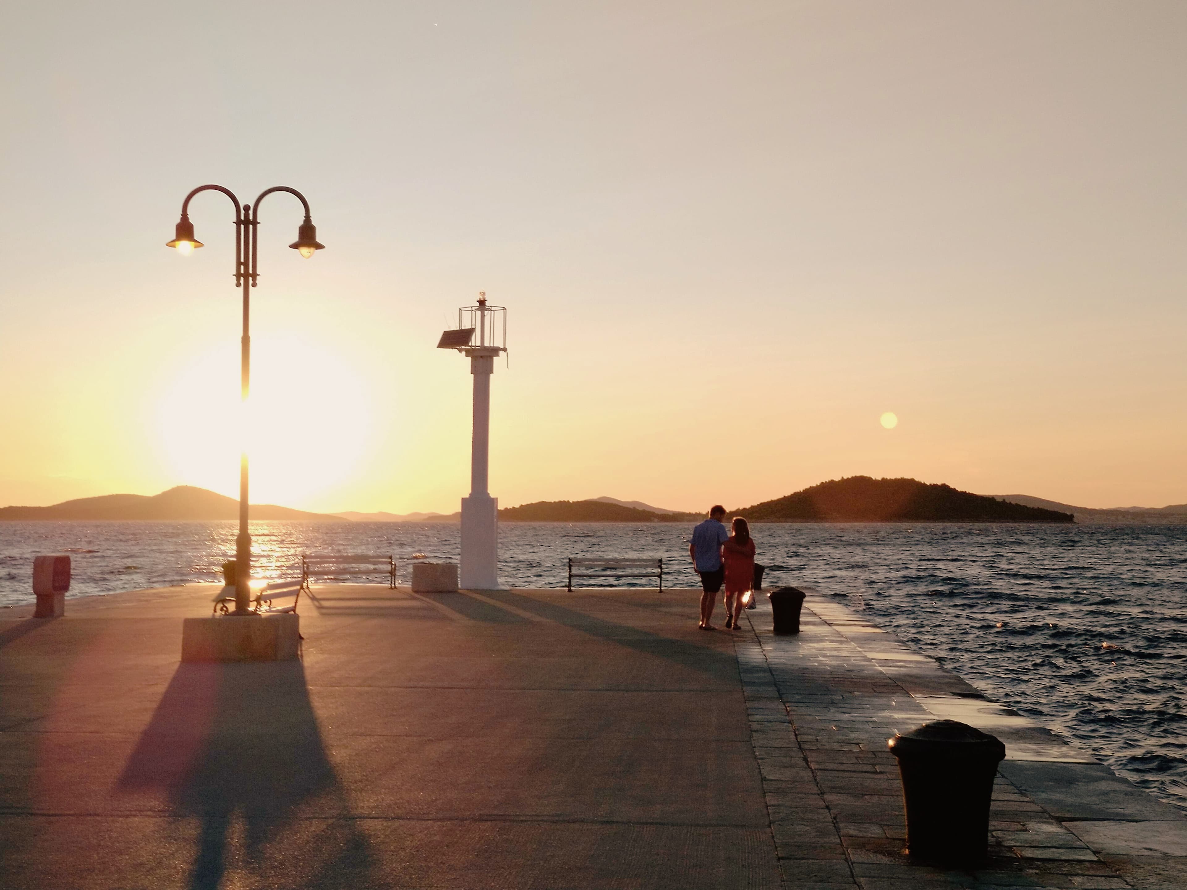 Photo of Matt and Catherine in front of a sunset on a holiday to Croatia